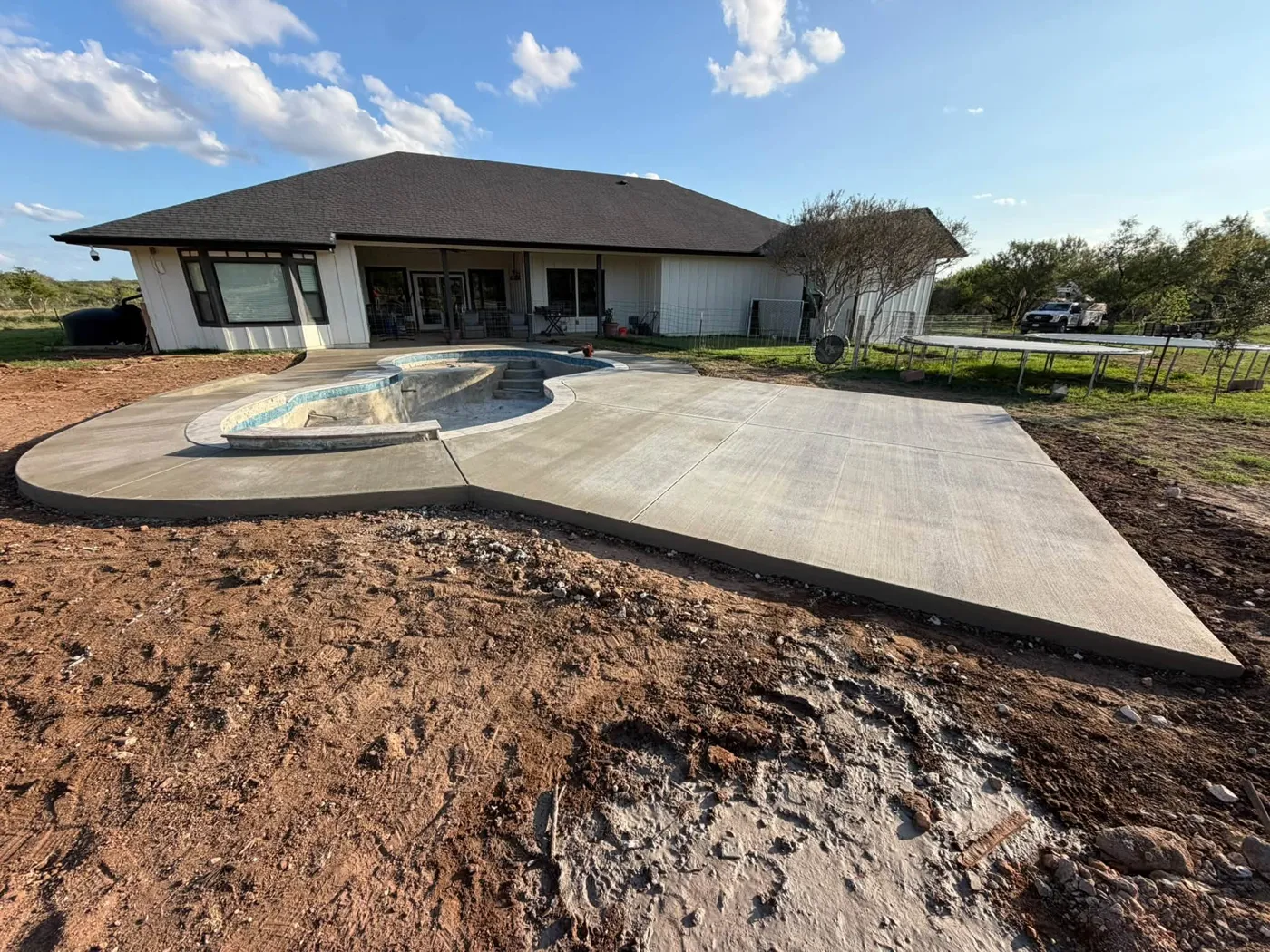 Pool deck & house by JGH Concrete